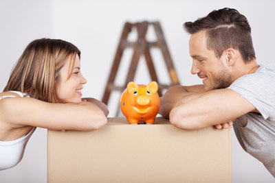 Photo of couple looking at piggy bank